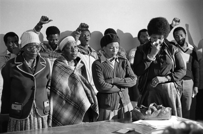 Gille de Vlieg. 'Pauline Moloise (mother of Ben), two women & Winnie Madikizela Mandela mourn at the Memorial Service for Benjamin Moloise, who was hanged earlier that morning. Khotso House, Johannesburg, October 18, 1985' 1985