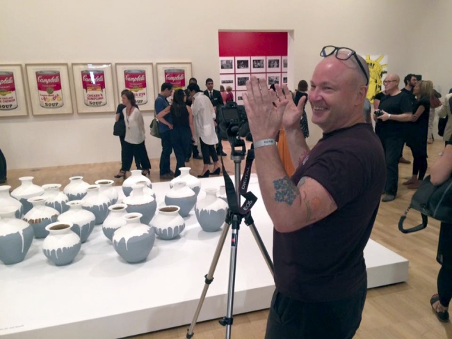 Marcus photographing the the exhibition 'Andy Warhol | Ai Weiwei' at the National Gallery of Victoria