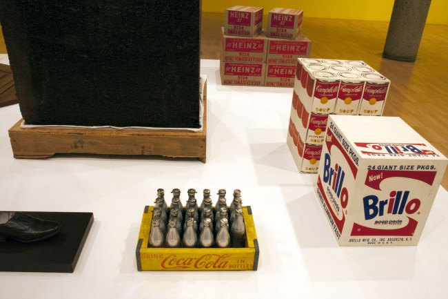Installation view of the third room including Ai Weiwei's 'Tonne of Tea' (2006) and And Warhol's 'Brillo Soap Pads Box' (1964) and 'You're in' (1967)