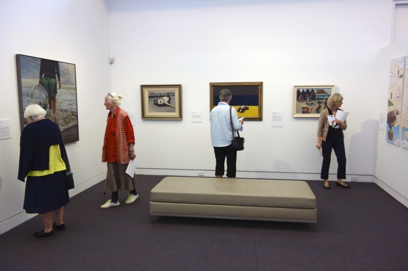 Installation view of the exhibition 'On the beach' at the Mornington Peninsula Regional Art Gallery showing on the far wall, Charles Blackman's 'Sunbather' (c. 1954) and Arthur Boyd's 'Kite flyers (South Melbourne)' (1943)