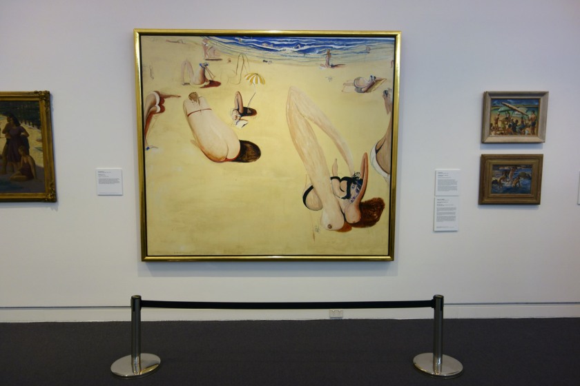 Installation view of the exhibition 'On the beach' at the Mornington Peninsula Regional Art Gallery showing in the centre, Brett Whiteley's 'Balmoral' (1975-1978). To the left of this painting is Nancy Kilgour's 'Figures on Manly Beach' (1930) and to the right Norma Bull's 'Bathing Beach' (c. 1950-1960s) with at bottom, George W. Lambert's 'Anzacs bathing in the sea' (1915)