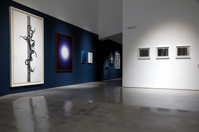Installation view of the exhibition Emanations: The Art of the Cameraless Photograph at the Govett-Brewster Art Gallery with, at left, work by Adam Fuss and, at right, Lisa Clunie