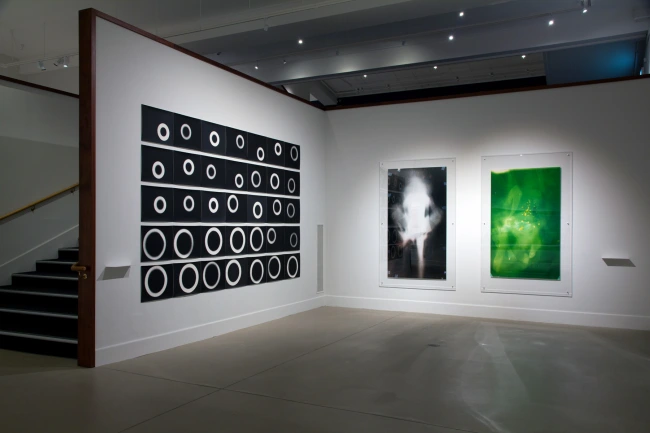 Installation view of Gavin Hipkins (New Zealand) ‘The Coil’ 1998 (left) and Lucinda Eva-May as part of the exhibition 'Emanations: The Art of the Cameraless Photograph' at the Govett-Brewster Art Gallery