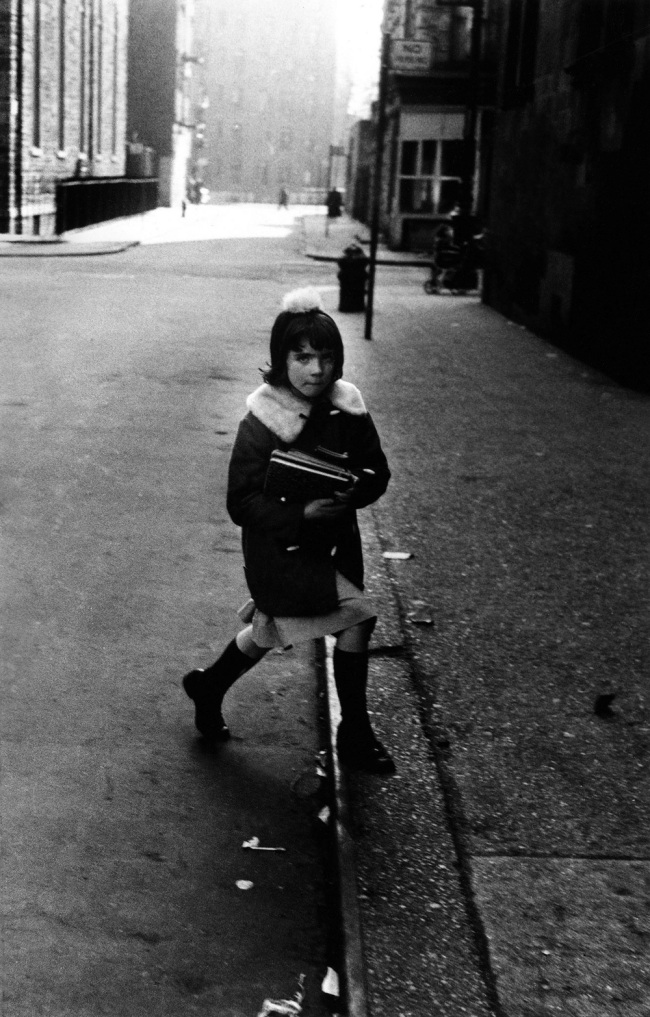 Diane Arbus (American, 1923-1971) 'Girl with schoolbooks stepping onto the curb, N.Y.C., 1957' 1957