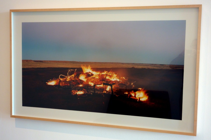 Installation view of Rosemary Laing's 'work burning Ayer #12' (2003, C Type photograph, Art Gallery of New South Wales, Sydney) from the series 'one dozen unnatural disasters in the Australian landscape'