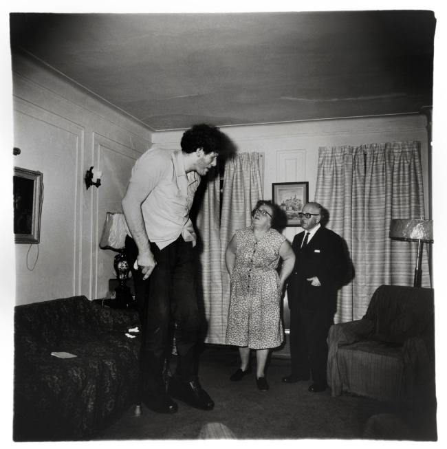 Diane Arbus (American, 1923-1971) 'A Jewish giant at home with his parents in the Bronx, N.Y., 1970' 1970