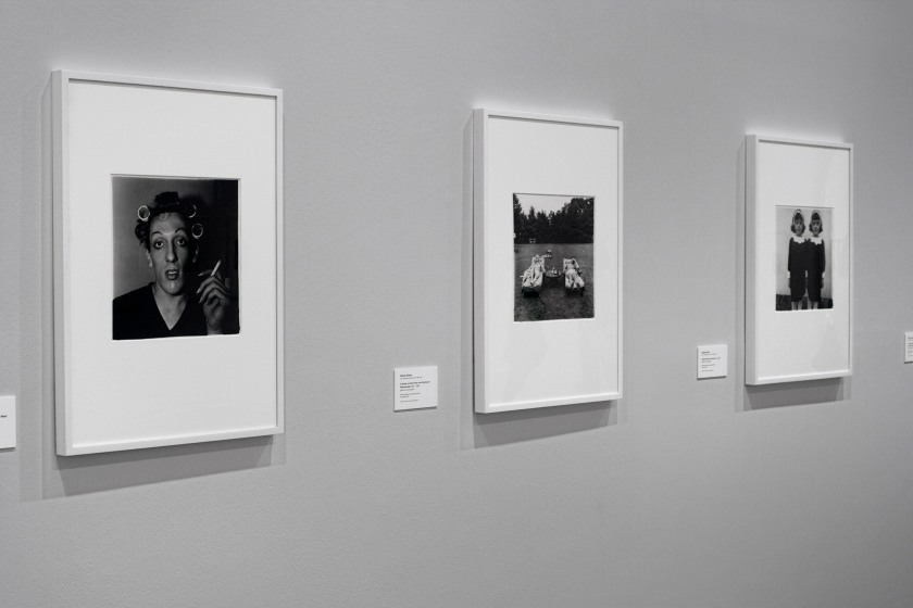Installation view of the exhibition 'Diane Arbus: American Portraits' at the Heide Museum of Modern Art, Melbourne showing from left to right, Diane Arbus' 'Boy with a straw hat waiting to march in a pro-war parade, N.Y.C.' 1967; 'A young man in curlers at home on West 20th St., N.Y.C.' 1966; and 'A Family on Their Lawn One Sunday in Westchester, New York' 1968
