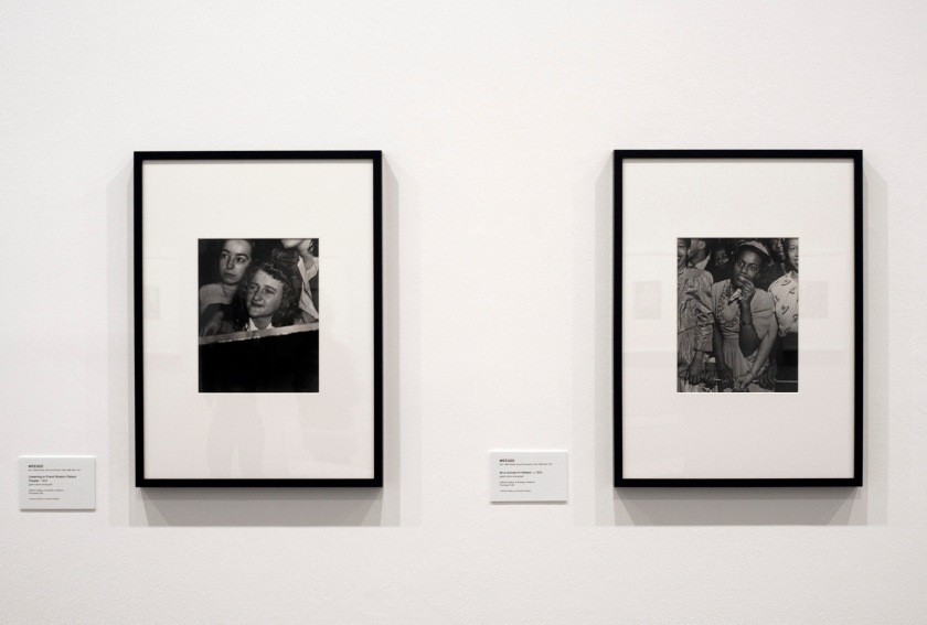 Installation view of the exhibition 'Diane Arbus: American Portraits' at the Heide Museum of Modern Art, Melbourne showing at left, Weegee's 'No title (listening to Frank Sinatra, Palace theatre)' c. 1944; and at right, Weegee's 'No title (at a concert in Harlem)' c. 1948