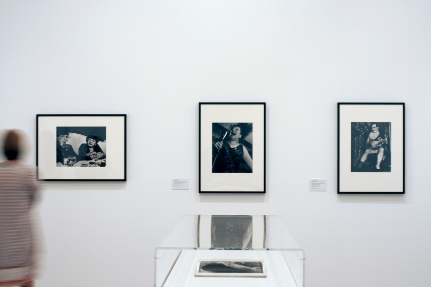 Installation view of the exhibition 'Diane Arbus: American Portraits' at the Heide Museum of Modern Art, Melbourne showing from left to right, Lisette Model's 'Fashion show, Hotel Pierre, New York City' 1940-1946; Lisette Model's 'Cafe Metropole, New York City' c. 1946; and Lisette Model's 'Albert-Alberta, Hubert's 42nd St Flea Circus, New York [Albert/Alberta]' c. 1945