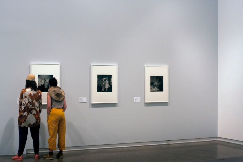 Installation view of the exhibition 'Diane Arbus: American Portraits' at the Heide Museum of Modern Art, Melbourne showing from left to right, Diane Arbus' 'A Jewish giant at home with his parents in the Bronx, N.Y.' 1970; 'Untitled (1)' 1970-1971; and 'Mexican dwarf in his hotel room N.Y.C.' 1970
