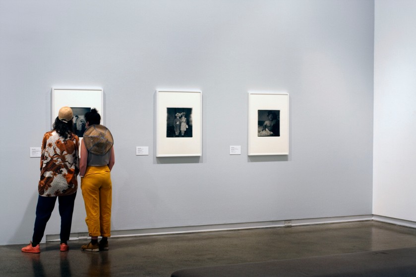 Installation view of the exhibition 'Diane Arbus: American Portraits' at the Heide Museum of Modern Art, Melbourne showing from left to right, Diane Arbus' 'A Jewish giant at home with his parents in the Bronx, N.Y.' 1970; 'Untitled (1)' 1970-1971; and 'Mexican dwarf in his hotel room N.Y.C.' 1970