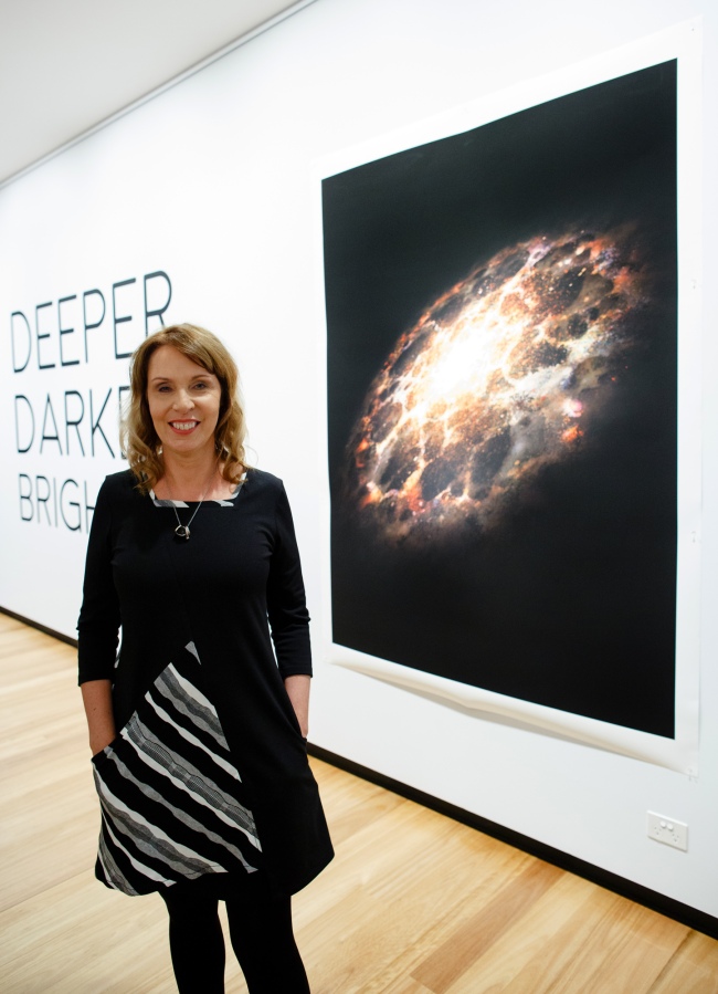 Pamela Bain in front of her work 'Electric Cosmic' 2018 at the opening of the exhibition 'Deeper Darker Brighter' at Town Hall Gallery, Hawthorn Arts Centre, Melbourne