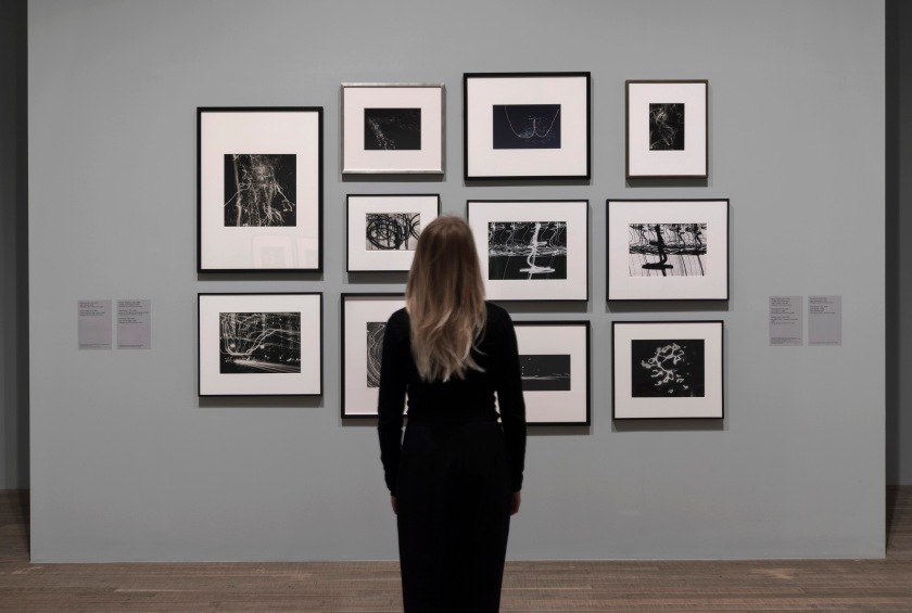 Installation view of the exhibition 'Shape of Light: 100 Years of Photography and Abstract Art' at Tate Modern, London showing at top left, Nathan Lerner's 'Light Tapestry'; and at centre right, Otto Steinert's 'Luminogram II' (1952)