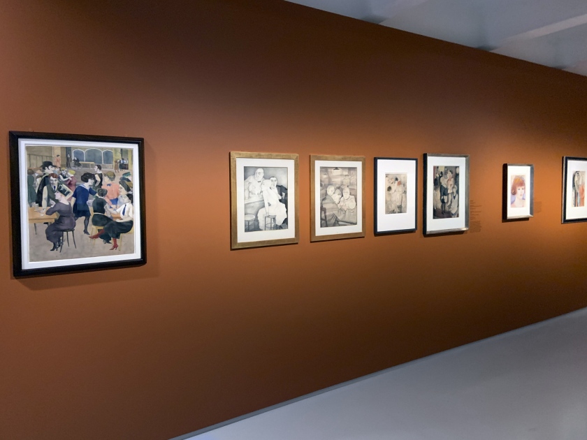 Installation view of the exhibition 'Into the Night: Cabarets and Clubs in Modern Art' at the Barbican Art Gallery, London with Rudolf Schlichter's 'Damenkneipe' (Women's Club) c. 1925 at left, followed by work by Jeanne Mammen