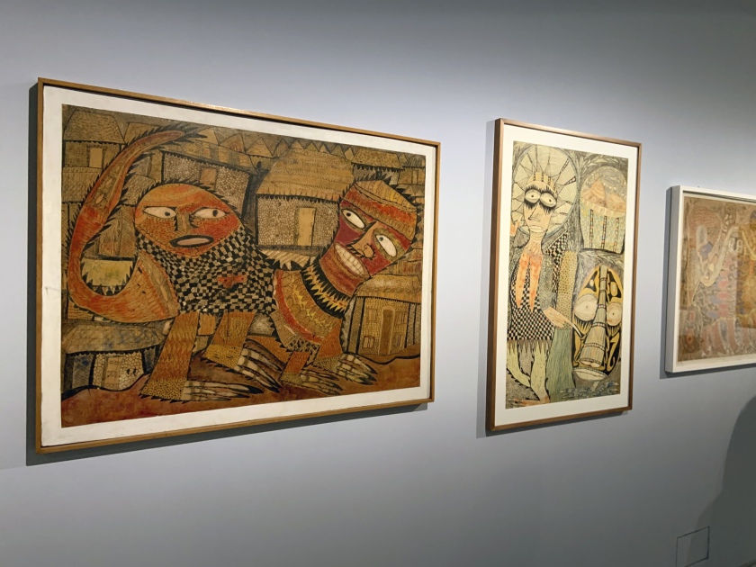 Installation view of the exhibition 'Into the Night: Cabarets and Clubs in Modern Art' at the Barbican Art Gallery, London showing at left, Twins Seven-Seven 'Devil's Dog' (1964) and at right, Twins Seven-Seven 'THE BEAUTIFUL LADY and THE FULLBODIED GENTLEMAN THAT REDUCED TO HEAD' (1967)