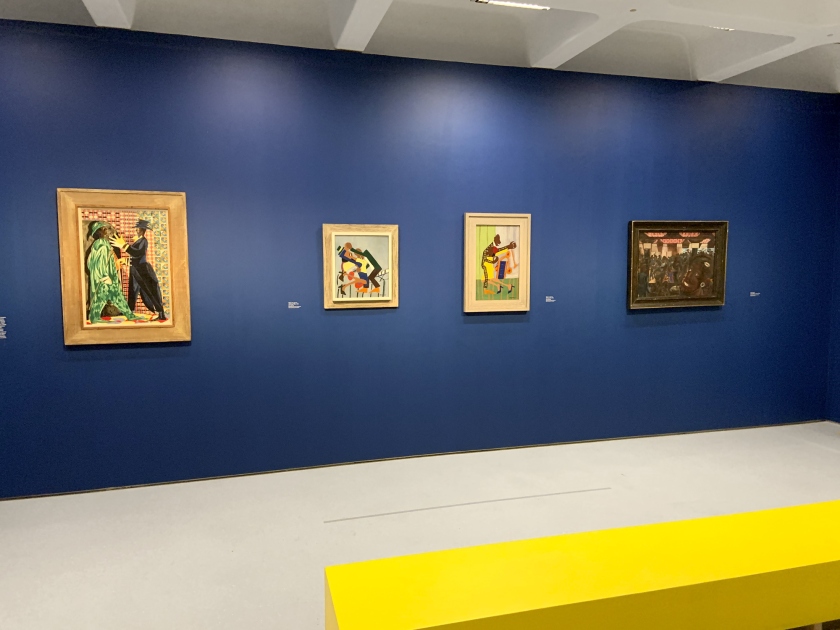 Installation view of the exhibition 'Into the Night: Cabarets and Clubs in Modern Art' at the Barbican Art Gallery showing at left, Jacob Lawrence's 'Vaudeville' (1951); at second left, William H, Johnson's 'Jitterbugs (III)' (c. 1941); at second right, William H, Johnson's 'Jitterbugs (II)' (c. 1941); and at right, Edward Burra's 'Savoy Ballroom, Harlem' (1934)