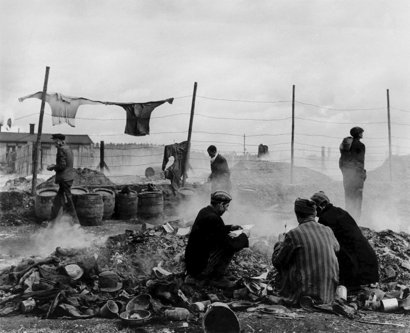 Lee Miller (American, 1907-1977) 'Freed prisoners scavenging in the rubbish dump, Dachau' Germany, 1945