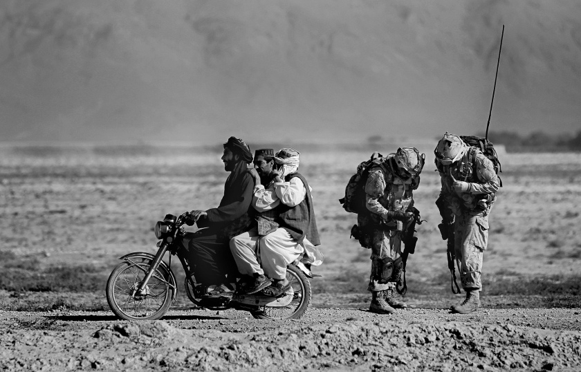 Anja Niedringhaus (German, 1965-2014) 'Afghan men on a motorcycle overtake Canadian soldiers' September 2010