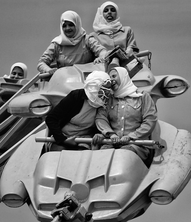 Anja Niedringhaus (German, 1965-2014) 'Palestinians enjoy a ride at an amusement park outside Gaza City, Gaza City, Gaza Strip' March 2006