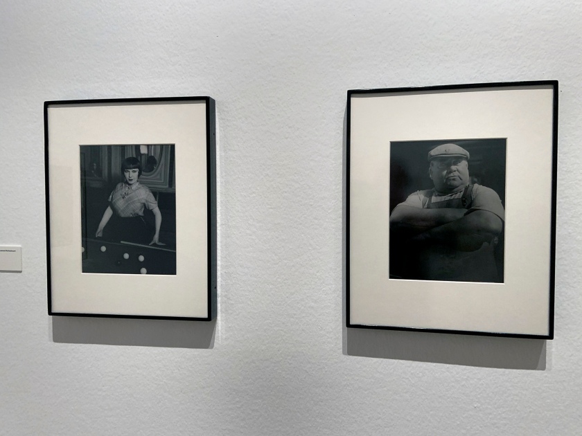 Installation view of the exhibition 'Brassaï' at Foam, Amsterdam showing photographs from the section Personages including at left 'Billiard Player, boulevard Rochechouart' 1932-1933; and at right, 'Market Porter, Les Halles' 1939