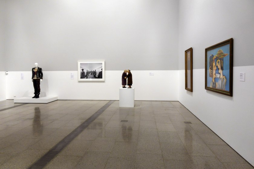 Installation view of the exhibition 'WHO ARE YOU: Australian Portraiture' at NGV Australia, Federation Square, Melbourne with second from left, Michael Cook's 'Tunnel No. 2' (2014); at third from left, Ron Mueck's 'Two Women' (2005)