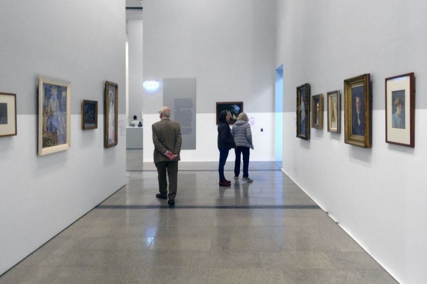 Installation view of the exhibition 'WHO ARE YOU: Australian Portraiture' at NGV Australia, Federation Square, Melbourne with at second left, Danila Vassielieff's 'Young girl (Shirley)' (1937)