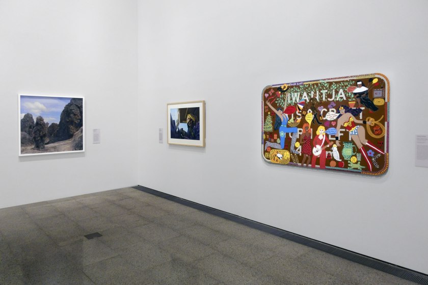 Installation view of the exhibition 'WHO ARE YOU: Australian Portraiture' at NGV Australia, Federation Square, Melbourne showing from left to right, Polixeni Papapetrou's 'Magma Man' (2012); Karla Dickens' 'Mrs Woods and 'Ere' (2013); and Kaylene Whiskey's 'Seven Sisters Song' (2021)