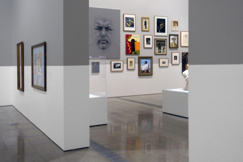 Installation view of the exhibition WHO ARE YOU: Australian Portraiture at NGV Australia, Federation Square, Melbourne showing at centre left, Bert Flugelman's 'self portrait' (1985)