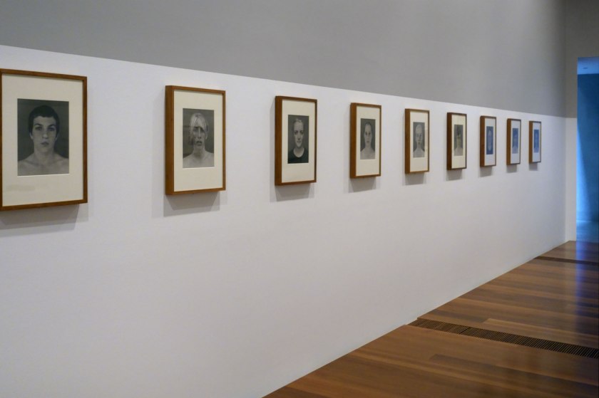 Installation view of the exhibition 'WHO ARE YOU: Australian Portraiture' at NGV Australia, Federation Square, Melbourne showing the work of Simon Obarzanek from his series '80 Faces' (2002)
