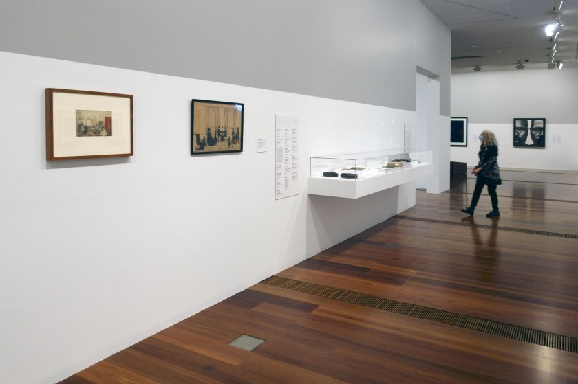 Installation view of the exhibition 'WHO ARE YOU: Australian Portraiture' at NGV Australia, Federation Square, Melbourne showing at left, Maria Brownrigg's 'An evening at Yarra Cottage, Port Stephens' (1857); and at second left, Samuel Metford's 'MacKenzie family silhouette' (1846)