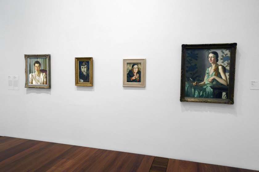 Installation view of the exhibition 'WHO ARE YOU: Australian Portraiture' at NGV Australia, Federation Square, Melbourne showing at left, Adelaide Perry's 'Rachel Roxburgh' (1939); at second left, Joy Hester's 'Pauline McCarthy' (1945); at second right, Sybil Craig's 'Peggy' (c. 1932); and at right, Constance Stokes' 'Portrait of a woman in a green dress' (1930)