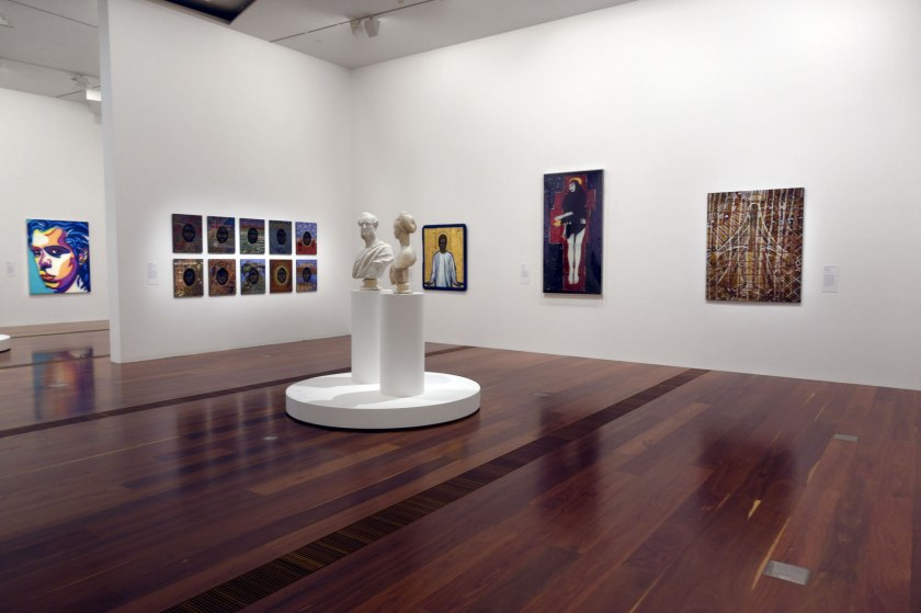 Installation view of the exhibition 'WHO ARE YOU: Australian Portraiture' at NGV Australia, Federation Square, Melbourne showing centre on the pedestal, Charles Summers' 'Edmund FitzGibbon and Sarah FitzGibbon' (1877); at left, Howard Arkley's 'Nick Cave' (1999); at second left, Julie Dowling's 'Federation 1901-2001' series (2001) and at second right, Julie Rrap's 'Persona and shadow: Madonna' (1984)