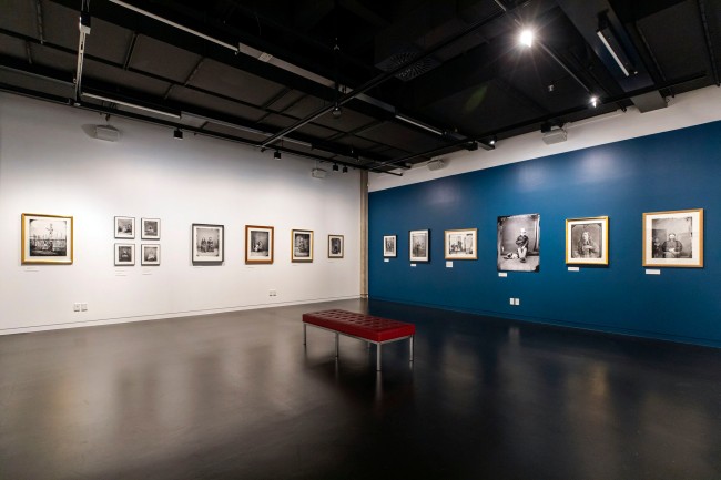 Installation view of the exhibition 'Between skin & shirt: The photographic portraits of William Harding' at the National Library of New Zealand Gallery, Wellington
