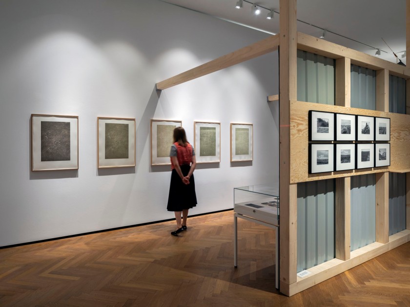 Installation view of the exhibition 'Mining Photography. The Ecological Footprint of Image Production' at the Museum für Kunst und Gewerbe Hamburg showing at left, heliogravures by Susanne Kriemann