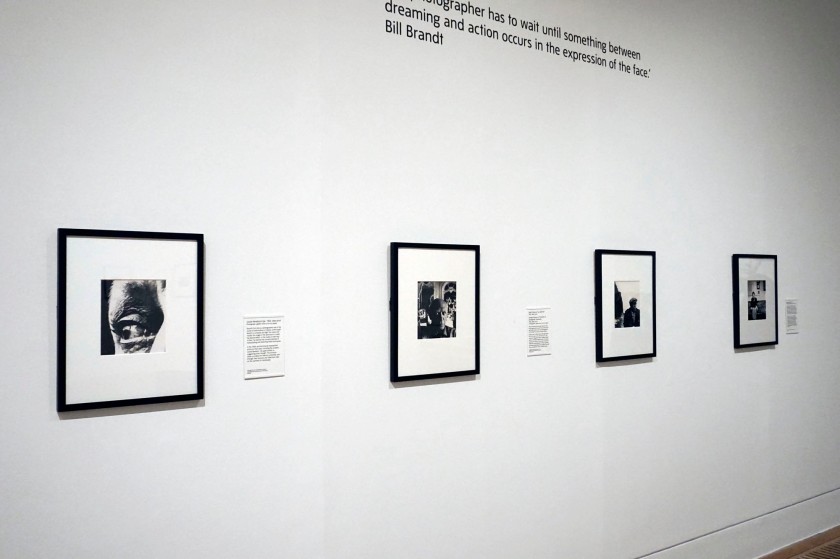 Installation view of the exhibition 'Bill Brandt: Inside the Mirror' at Tate Britain, London, October 2022 - January 2023 showing from left to right, Brandt's photographs 'Louise Nevelson's Eye' (1963); 'Pablo Picasso at "La Californie"' (1955); 'Georges Braque on the beach at Varengeville, Normandy' (1955); and 'Glenda Jackson' (1971)