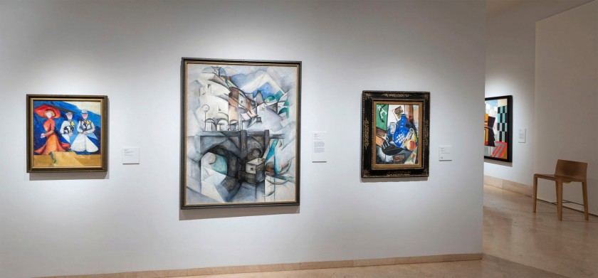 Installation view of the exhibition In the 'Eye of the Storm: Modernism in Ukraine, 1900-1930s' at the Thyssen-Bornemisza Museum, Madrid showing three paintings by Alexandra Exter including at left, 'Three Female Figures' (1910) and at right 'Still Life' (1915)