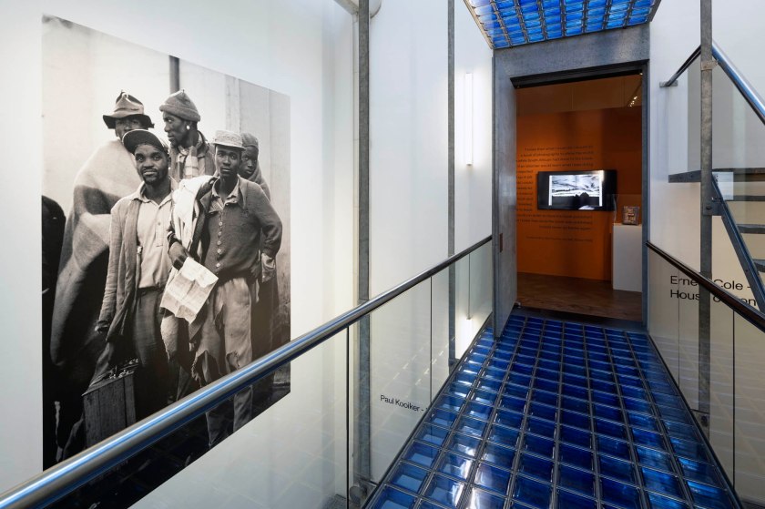Installation view of the exhibition 'Ernest Cole: House of Bondage' at Foam, Amsterdam showing at left, Cole's 'Pensive tribesmen, newly recruited to mine labour, awaiting processing and assignment' (1960-1966)