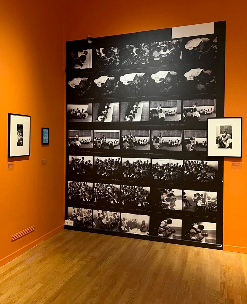 Installation view of the exhibition 'Ernest Cole: House of Bondage' at Foam, Amsterdam showing photographs from the section 'Education for Servitude': in the image at left, Cole's 'Earnest boy' (1960-1966); and at right, 'Teacher toward end of her day in school, South Africa' (1960-1966)