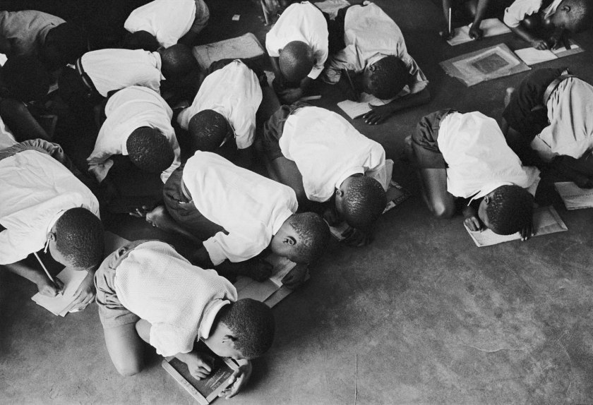 Ernest Cole (South African, 1940-1990) 'SOUTH AFRICA. 1960s. Students kneel on floor to write. Government is casual about furnishing schools for blacks' 1960-1966