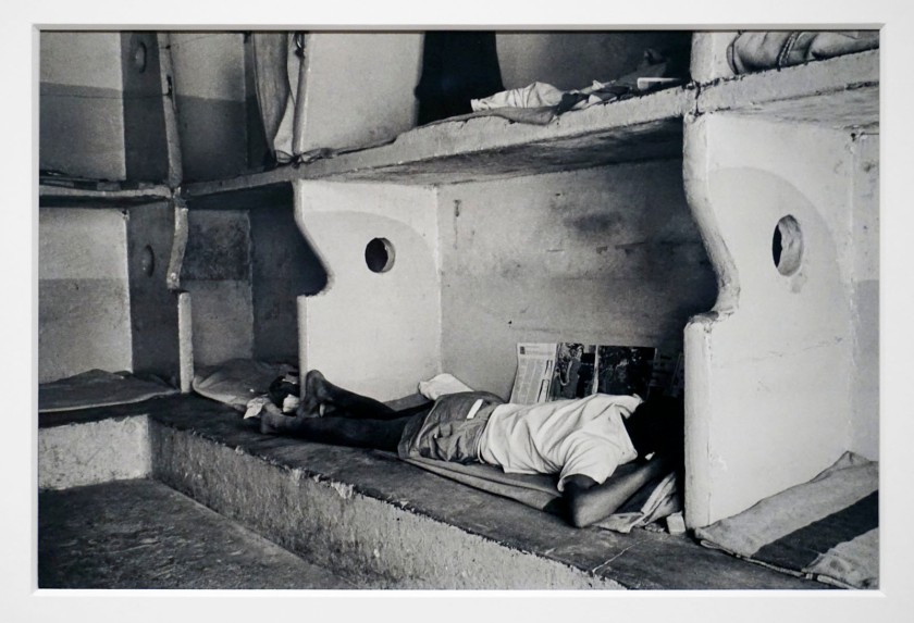 Ernest Cole (South African, 1940-1990) 'Miner sleeps on concrete slab, must supply own bedding' 1960-1966 (installation view)