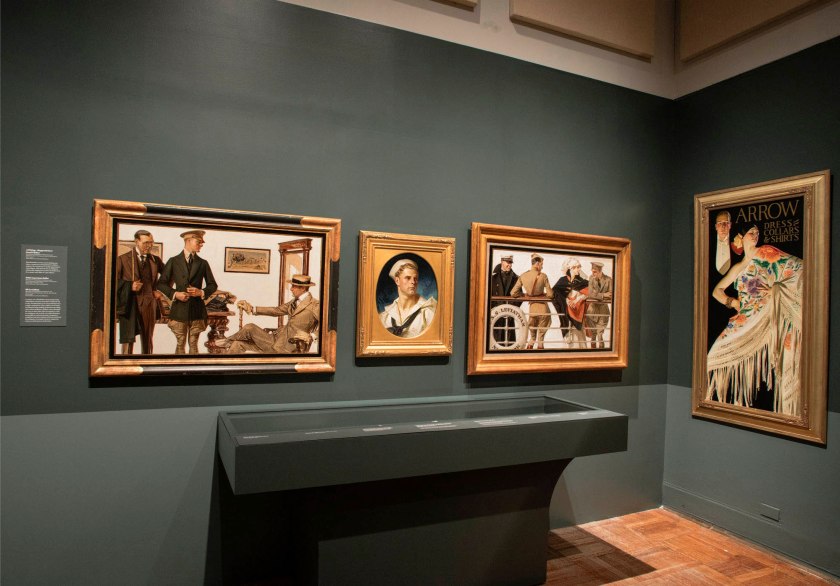 Installation view of the exhibition 'Under Cover: J.C. Leyendecker and American Masculinity' at the New-York Historical Society showing at centre, 'Portrait of an American Sailor, Charles Beach' (1918); at second right, 'The S.S. Leviathan' (1918); and at right, 'Man and Woman with Spanish Shawl' (1926)