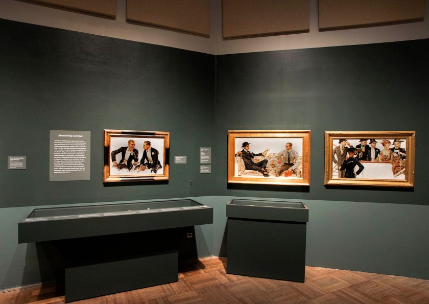 Installation view of the exhibition 'Under Cover: J.C. Leyendecker and American Masculinity' at the New-York Historical Society at left, 'The Donchester – the Cluett Dress Shirt' (1911); and at right, In the 'Stands 2' (1913)