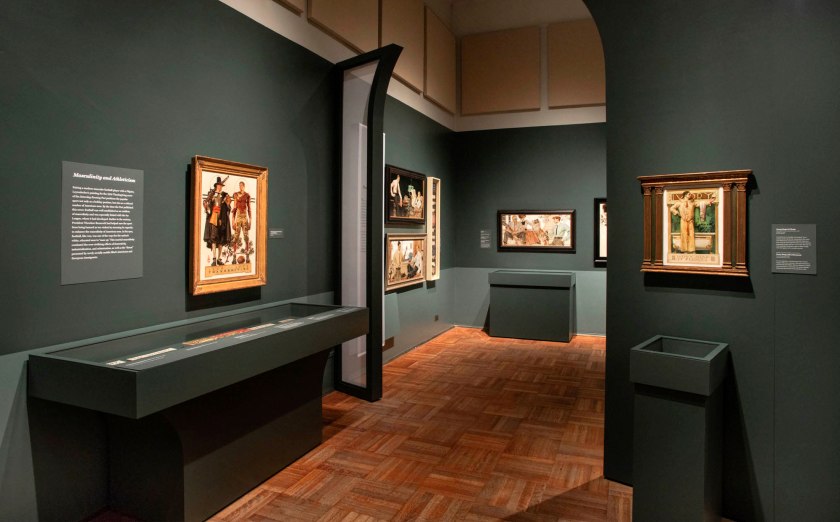 Installation view of the exhibition 'Under Cover: J.C. Leyendecker and American Masculinity' at the New-York Historical Society showing at left, 'Thanksgiving: 1628-1928 (Pilgrim and Football Player)' (1928); and at right, 'Ivory Soap It Floats' (1900)