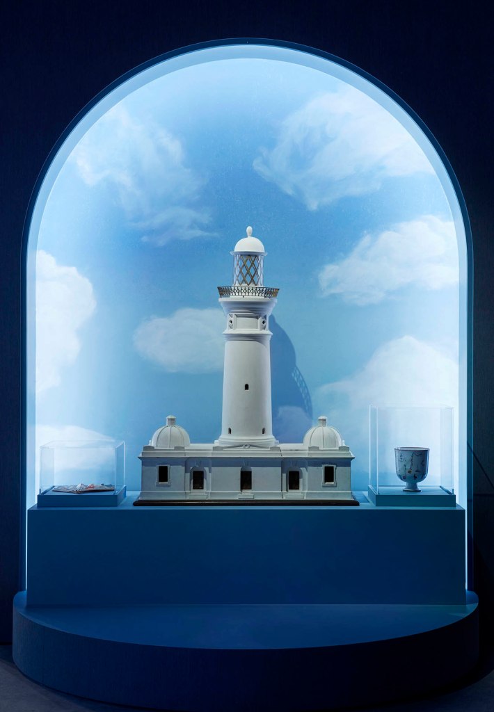 Installation view of the exhibition '1,001 Remarkable Objects' at Powerhouse Ultimo, Sydney showing at centre an architectural model of the Macquarie Lighthouse made by the Department of Navigation, Sydney, New South Wales, Australia, c. 1880