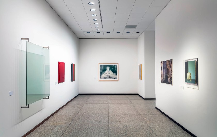 Installation view of the exhibition 'Gerhard Richter. 100 Works for Berlin', State Museums in Berlin, Neue Nationalgalerie, April 1, 2023 to 2026 showing at centre, 'Tante Marianne' (1965/2019, below); and at right, 'Skull' (1983, above) © Gerhard Richter 2023