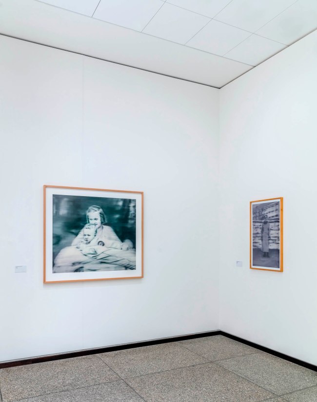 Installation view of the exhibition 'Gerhard Richter. 100 Works for Berlin', State Museums in Berlin, Neue Nationalgalerie, April 1, 2023 to 2026 showing at left, 'Tante Marianne' (1965/2019, below); and at right, 'Uncle Rudy' (1965/2000, below)