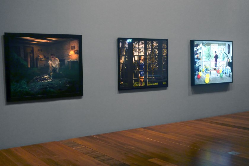 Installation view of the exhibition 'Photography: Real & Imagined' at The Ian Potter Centre: NGV Australia, Melbourne showing at left, Gregory Crewdson's 'Untitled' (1999) from the Twilight series (1998-2002); at centre, Malerie Marder's 'Untitled' (2001); and at right, Anne Zahalka's 'Sunday, 2:09pm' (1995) 