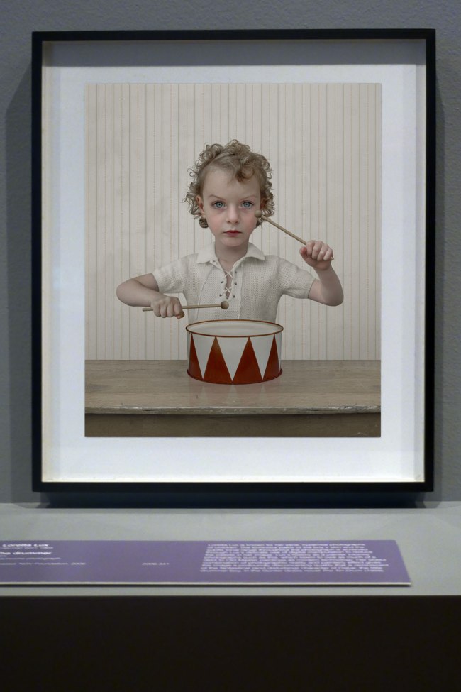 Installation view of the exhibition 'Photography: Real & Imagined' at The Ian Potter Centre: NGV Australia, Melbourne showing Loretta Lux's 'The Drummer' (2004)