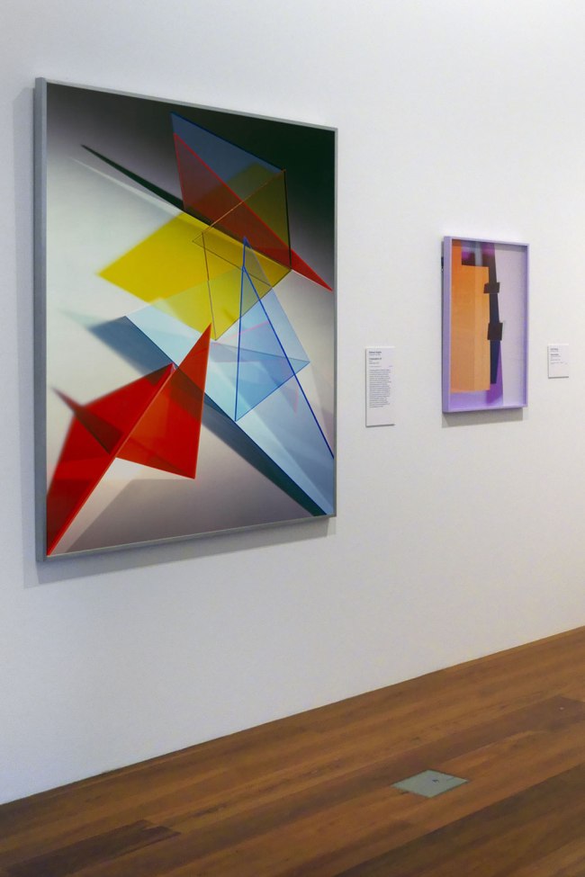 Installation view of the exhibition Photography: Real & Imagined at The Ian Potter Centre: NGV Australia, Melbourne showing at left, Barbara Kasten's Composition 8T (2018); and at right, Lydia Wegner's Purple square (2017)