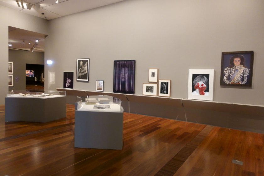 Installation view of the exhibition 'Photography: Real & Imagined' at The Ian Potter Centre: NGV Australia, Melbourne showing at second right, Pat Brassington's 'Rosa' (2014); and at right, Yvonne Todd's 'Werta' (2005)